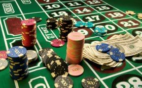 Live Texas Poker table with dealer and community cards